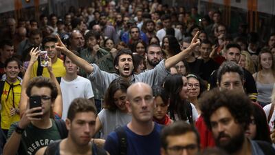 A man shouts slogans as people arrive at Plaza Catalunya station during a partial regional strike called by pro-independence parties and unions in Barcelona, Spain, October 3, 2017.
