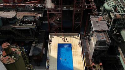 Visitors enjoying the water of the 'Werksschwimmbad' swimming pool at Zeche Zollverein in Essen, western Germany. The swimming pool at the UNESCO World Heritage Site Zollverein was designed by Frankfurt-based artists Dirk Paschke and Daniel Milohnic in 2001. AFP