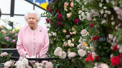 Queen Elizabeth looks at a display of roses in 2018. Getty Images