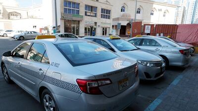 Readers express frustration with taxis that often block their parking areas. Christopher Pike / The National
