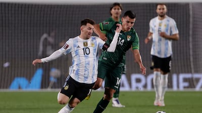 Argentina's Lionel Messi and Moises Villaroel of Boliva batttle for possession. AFP