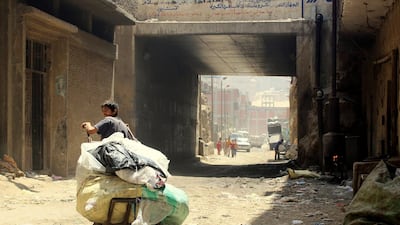A boy at the main gate of the Manshiyat Naser slum in Cairo, leaving with his cart to the city to collect garbage. Sandor Jaszberenyi / The National