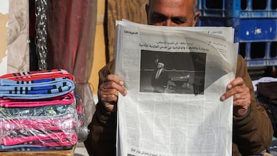A vendor reads a newspaper a day after the inauguration ceremony of US President Donald Trump, in Baghdad on January 21. AFP