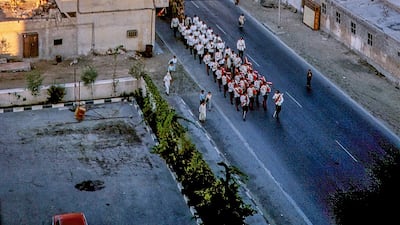 Life revolved around Dubai Creek during this time. It was also the site of the legendary Plaza Cinema that can been seen on the right, while the Dubai Police pipe band parades through the streets. The Plaza was renamed the Golden Cinema in latter years. It closed in 2015.