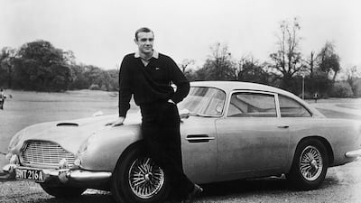 James Bond star Sean Connery stands with the Aston Martin DB5 on the set of 'Goldfinger' in 1964