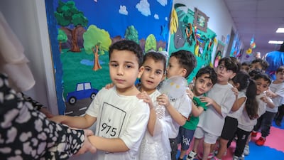 Pupils wait in line to enter the nursery