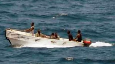 Some of the Somali pirates who held the MV Faina transit to shore under the observation of a US Navy ship.