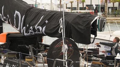 A member of Abu Dhabi Ocean Racing checks the yacht at Alicante's harbour on the eve of the start of the Volvo Ocean Race.