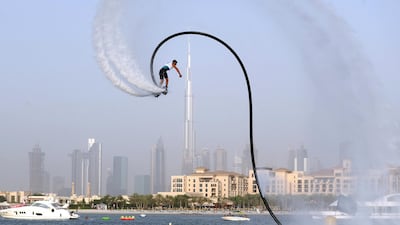 People compete in the flyboard section of the Dubai Watersports Summer Week.