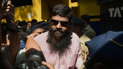 An Indian prisoner, convicted of involvement in the 2006 Mumbai train blasts, walks to a police van on his way to a special court in Mumbai. Punit Paranjpe / AFP Photo