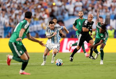 Lionel Messi, centre, evades the Algeria defence on the way to scoring the first of his three goals. AFP