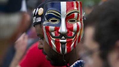 An anti-GOP protester wears a Guy Fawkes mask, symbol of the occupy movement, during a protest rally in downtown Tampa , Florida.