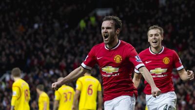 Manchester United's Juan Mata celebrates after scoring against Liverpool on Sunday in the Premier League. Jon Super / AP