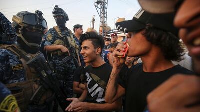 Iraqi protesters speaks with members of police in Baghdad's predominantly Shiite Sadr City. Demonstrations across Baghdad and the south have spiralled into violence over the last week, with witnesses reporting security forces using water cannons, tear gas and live rounds and authorities saying "unidentified snipers" have shot at protesters and police. On Sunday evening a mass protest in Sadr City in east Baghdad led to clashes that medics and security forces said left 13 people dead. AFP