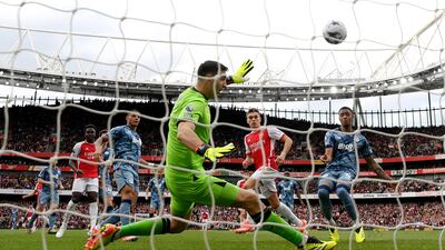 Aston Villa goalkeeper Emiliano Martinez makes a save from Leandro Trossard of Arsenal. Getty Images
