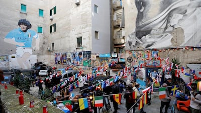 People gather on the streets of Naples to mourn the death of Diego Maradona. Reuters