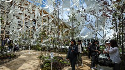 Visitors can look out at the expo through the origami-inspired translucent motifs that make up the facade. Victor Besa / The National