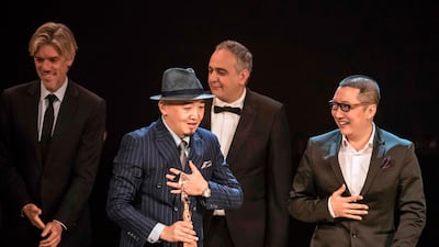 Chinese directors Zhang Chong and Zhang Bo receive the Bronze Pyramid for 'The Fourth Wall' during the closing ceremony of the 41st Cairo International Film Festival. AFP