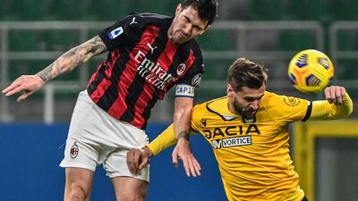 AC Milan's Italian defender Alessio Romagnoli and Udinese's Spanish forward Fernando Llorente go for a header. AFP