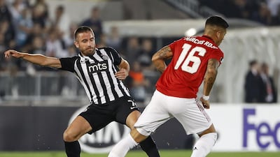 Marcos Rojo is challenged by Zoran Tosic at the Partizan Stadium. Getty Images