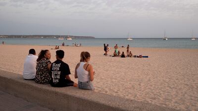 12. A family enjoys the sunset in Platja d'Or in Palma de Mallorca. AFP