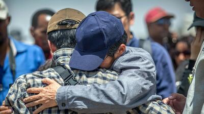 Family members hug each other at the scene where the Ethiopian Airlines Boeing 737 Max 8 crashed shortly after takeoff on Sunday. AP