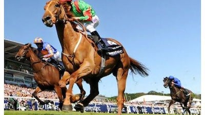 Dancing Rain, (foreground) ridden by jockey Johnny Murtagh, crosses the line in first place to win The Investec Oaks race.