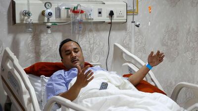Plane crash survivor Nepalese Ashish Ranjit, who escaped from the craft's window, is being treated at the Norvic Hospital in Kathmandu. Narendra Shrestha / EPA