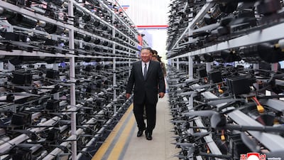 North Korean leader Kim Jong-un walks past a vast array of drones at the Unmanned Aeronautical Technology Development 2026, in Kangwon. AFP
