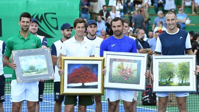Serbia's Novak Djokovic, Aljaz Bedene from Slovenia, Ivan Dodig from Croatia and Bosnian player Aldin Setkic pose with theirs gifts after an exhibition match. AFP