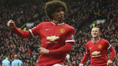 Manchester United's Marouane Fellaini celebrates after scoring against Manchester City on Saturday with teammate Wayne Rooney behind him. Paul Ellis / AFP / April 12, 2015