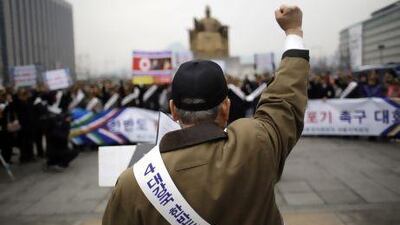 A South Korean protester at a rally demanding the Korean Peninsula's peaceful unification and denouncing North Korea's nuclear test near the US Embassy in Seoul on Monday. Lee Jin-man / AP Photo