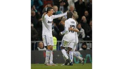 Real Madrid's Cristiano Ronaldo, left, celebrates scoring against Valencia with teammates Lassana Diarra and Pepe. Victor R Caivano / AP Photo