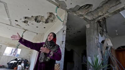 A Palestinian woman gestures inside her damaged home in the southern Gaza Strip. Reuters