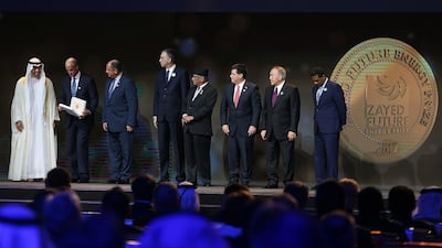 Sheikh Mohammed bin Zayed, Crown Prince of Abu Dhabi and Deputy Supreme Commander of the Armed Forces, with some of the business winners of the Zayed Future Energy Prize. Delores Johnson / The National