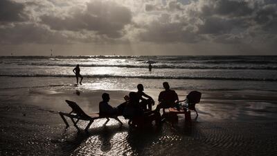 People enjoy the beachfront in Tel Aviv, Israel, on Saturday, May 22, 2021. AP