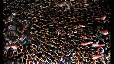 Egyptian protesters wave their hands and hold national flags during an anti-Morsi demonstration in Tahrir Square, Cairo, Egypt. Amr Nabil / AP Photo