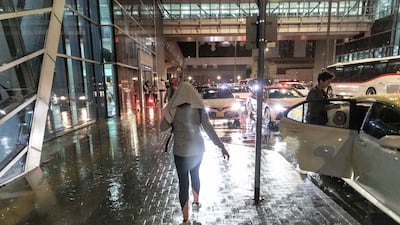 A pedestrian walks through the rain in Dubai. Antonie Robertson / The National