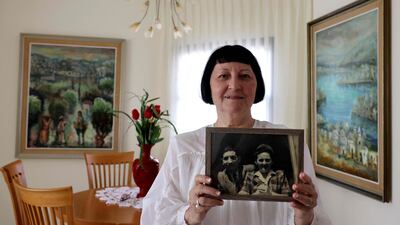 Shoshana Greenberg, 74, the daughter of a Holocaust survivor, holds a picture of her parents Regina and Israel, at her home in Tel Aviv.