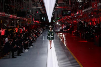 Mica Arganaraz walks the runway at the fashion debut of the first co-ed Ferrari collection. Getty Images