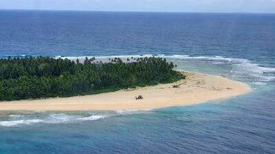 An Australian Army helicopter lands on Pikelot Island where three men were found safe and healthy after their giant SOS sign was spotted by warplanes. Australian Defence Force via AP