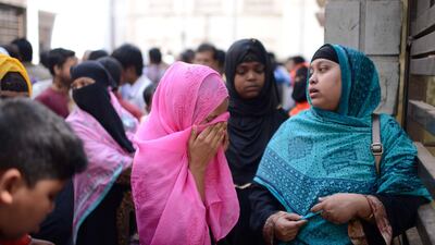 A woman cries outside a morgue in Dhaka, Bangladesh, Thursday, Feb. 21, 2019. A devastating fire raced through at least five buildings in an old part of Bangladesh's capital and killed scores of people. (AP Photo/Mahmud Hossain Opu )