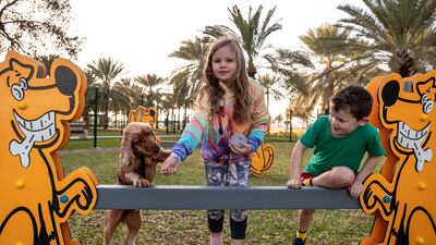 Ethan Mulholland, 6, and Beth, 8, play with their dog Marley at the new park in Al Khubeirah. All photos: Victor Besa / The National
