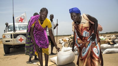 Women carry a sack of seeds in the opposition controlled town of Thonyor. The United Nations warned of a growing risk of mass deaths from starvation among people living in conflict and drought-hit areas of the Horn of Africa and Nigeria. AFP