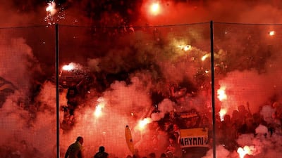 AEK Athens fans light up flares during Wednesday's Greek Cup quarter-final against Olympiakos. Petros Giannakouris / AP / March 11, 2015