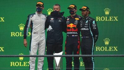 Race winner Max Verstappen, second left, George Russell, left, who finished second, and third placed Lewis Hamilton, right. Getty