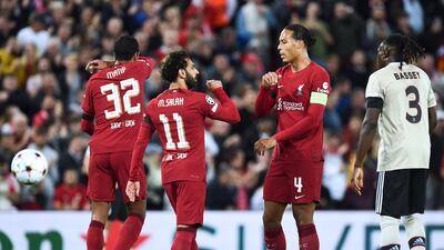 Mohamed Salah celebrates with teammate Virgil van Dijk after scoring for Liverpool against Ajax in their Champions League clash. EPA