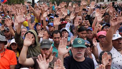 Citizens raise their hands as Juan Guaido, President of the Venezuelan Parliament, announces that he assumes executive powers, in Caracas, Venezuela, 23 January 2019. EPA