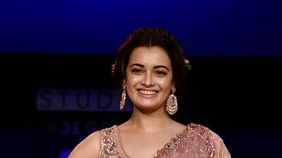 Actress Dia Mirza flashes her famous smile in a Moksha & Hiral ensemble. AFP