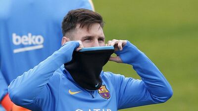 Barcelona’s Lionel Messi covesr up at training on Tuesday in Japan during the Club World Cup. Toru Hanai / Reuters